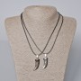 Twin pendants 'Fang' with black enamel and silvery metal, 35×12 mm; length 45–50 cm