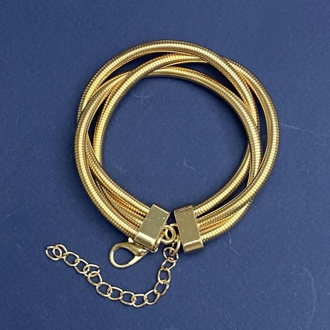 Triple bracelet in gold-tone metal with an extension chain