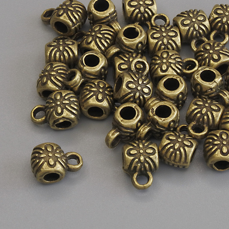 Bronze-colored bail hardware, dimensions 8.5×6 mm ±, hole diameters 2.8 mm ± and 1.8 mm ±; packaging 20 g (~28 pcs)