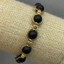 Shungite bracelet with smooth beads, diameter about 8 mm, with metal inserts, length about 18 cm, stretch