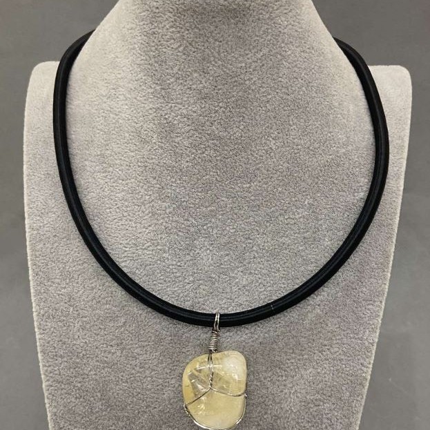 Citrine pendant in a woven setting, 20x30 mm, on a rubber cord with a 5 mm diameter, 45 cm + 5 cm extender chain