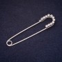 Brooch pin 70×16 mm with white crystals, silver-colored metal