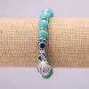 Turquoise Charm Bracelet (single ) with blue “Evil Eye” beads on elastic cord, diameter 10 (±) mm, length 18 cm with inserts and a pendant