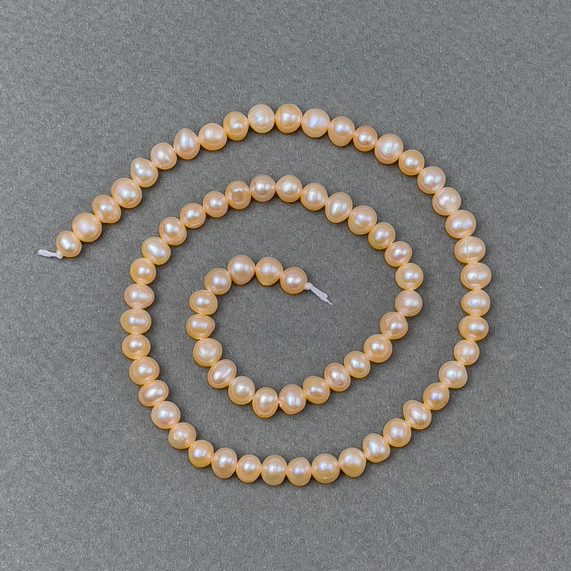 Peach river pearls on a strand, diameter 5–6×5–4 mm, length 36 cm