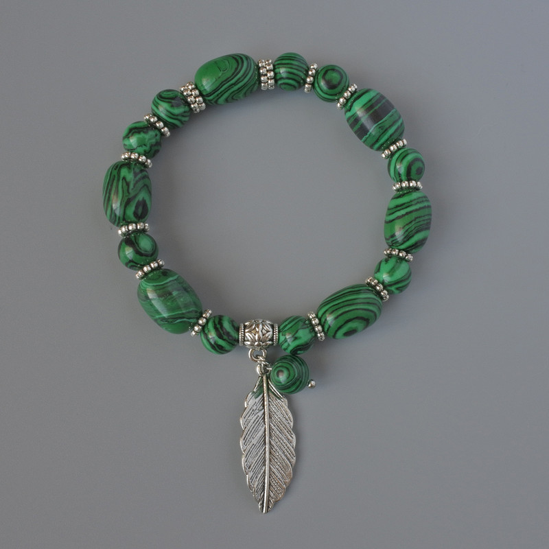 Malachite bracelet (pressed), bead diameters 10×14 mm and 8 mm, length 18 cm, with metal inserts (stretch)